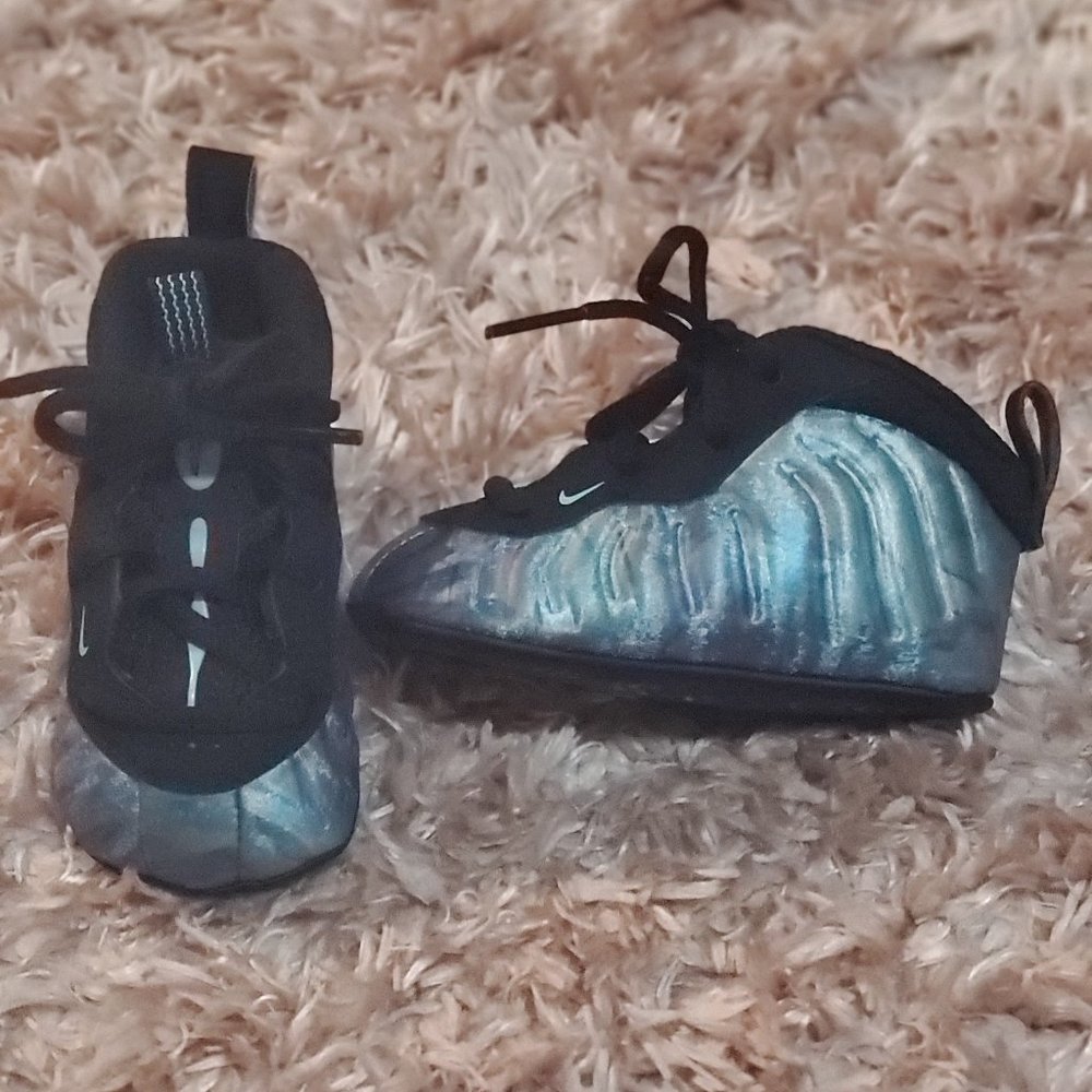 Aqua and black infant Nike Foamposites crib shoes.